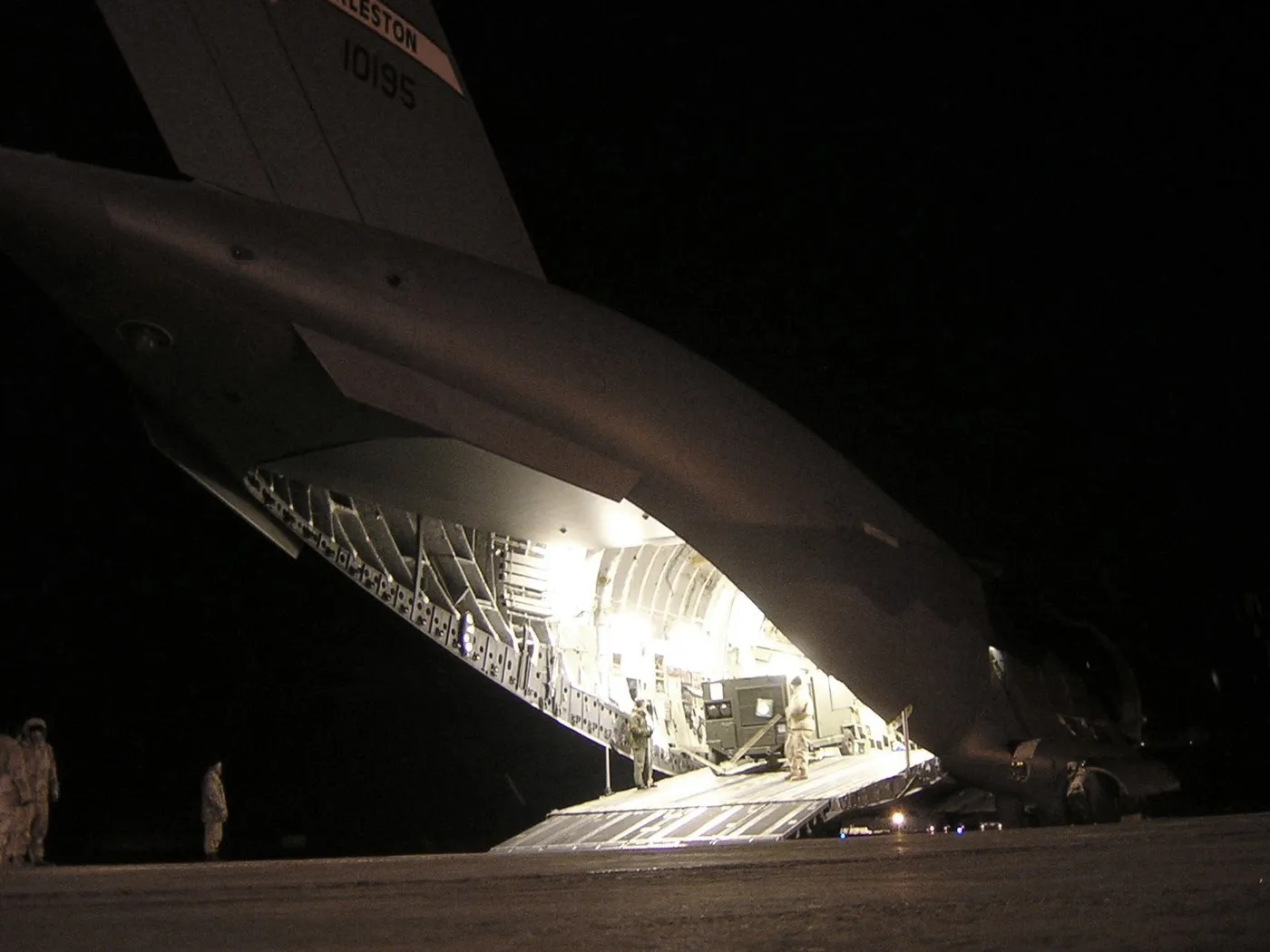 A C-17 Globemaster III being loaded at the Karshi-Khanabad (K2) airfield, Uzbekistan — the base was the key site of the operation’s first months (photograph from 2004; the base operated 2001–2005). Photo: U.S. Air Force. Licence: public domain. Source: Wikimedia Commons https://commons.wikimedia.org/wiki/File:C-17_Globemaster_III_from_the_416th_Air_Expeditionary_Group_being_loaded_at_Karshi-Khanabad_Airfield.jpg
